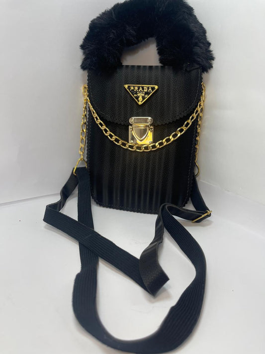 "Black Prada Handbag with Gold Chain Strap and Fluffy Handle"