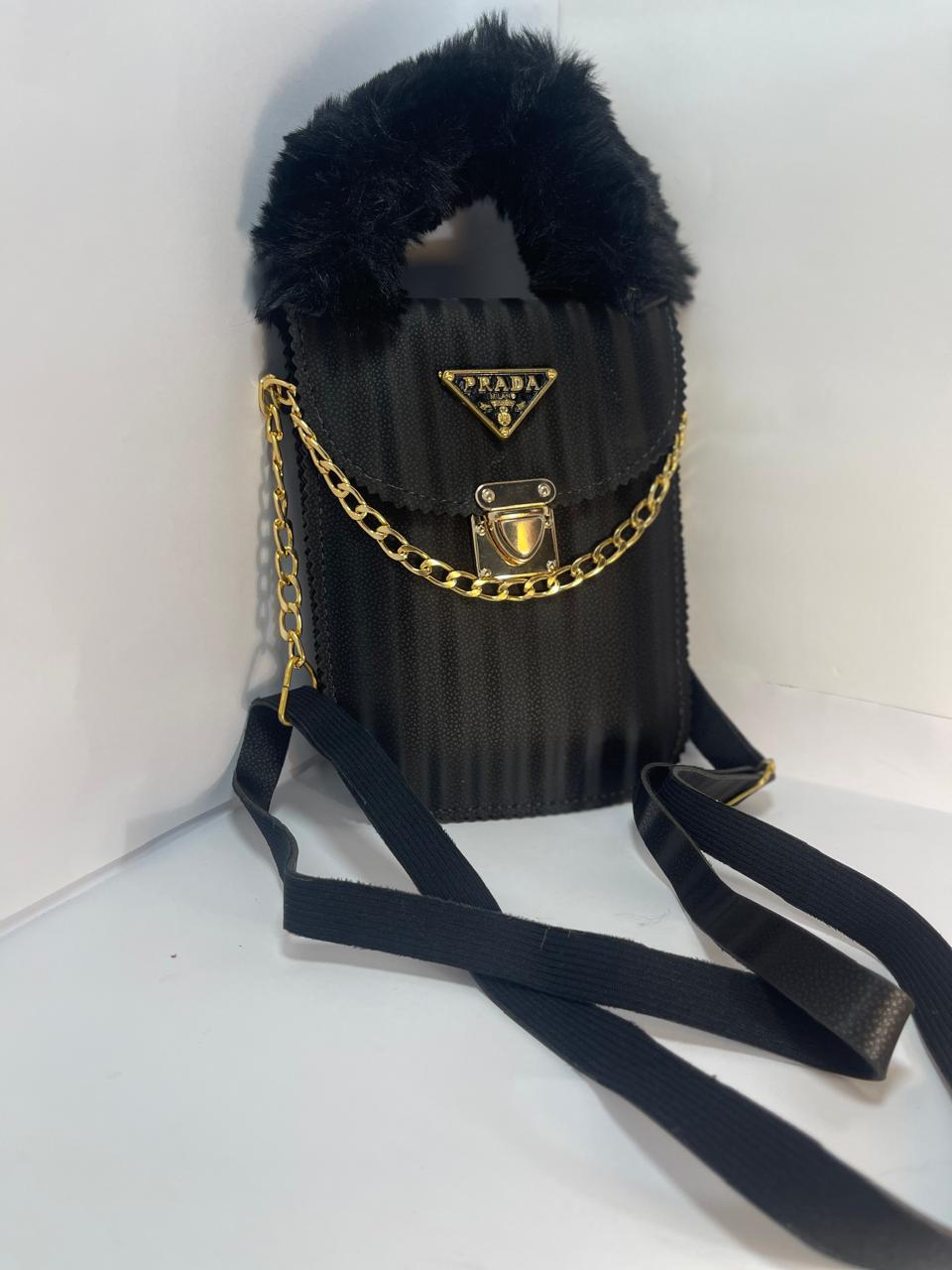 "Black Prada Handbag with Gold Chain Strap and Fluffy Handle"